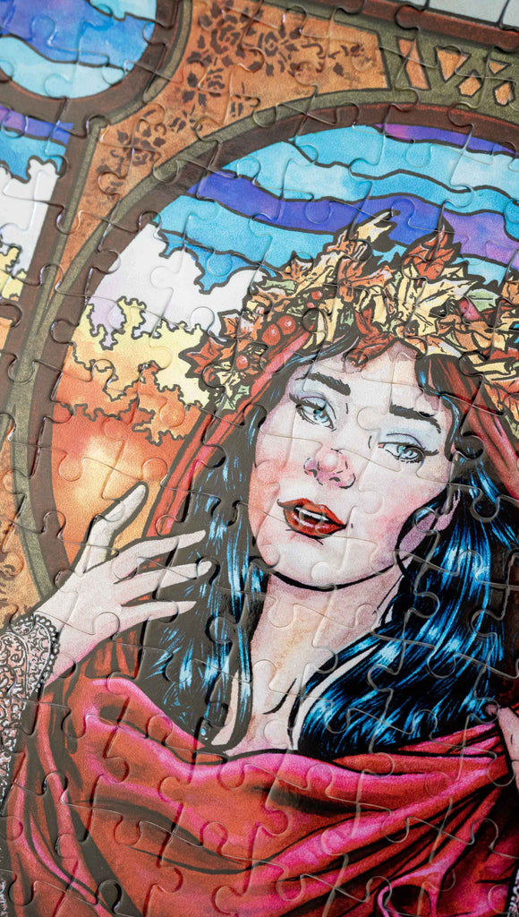 Zoomed in photo of Art Nouveau Puzzle featuring original artwork by Scott Christian Sava. The painting features a woman with a cloak and crown of autumn leaves standing in front of a stained glass window.