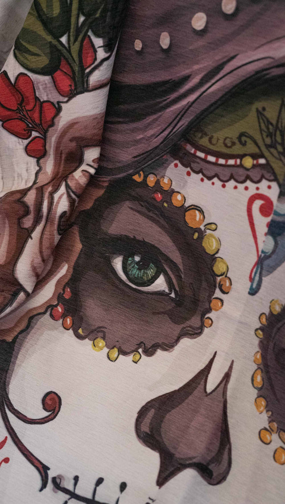 Decorative Chenille Tapestry printed with limited edition artwork by our Female Founder, Chriztina Marie. The artwork celebrates Dia De Los Muertos with a drawing of a girl wearing sugarskull makeup surrounded by a wreath of roses.