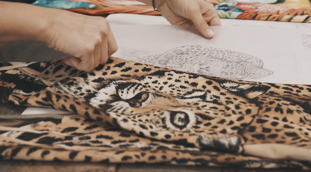 A still image from our extended "behind the seams" video that shows the pencil sketch of Leopard and the finished leggings side-by-side