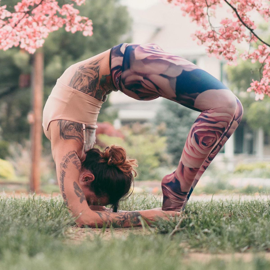 Girl doing an advanced wheel yoga pose while wearing WERKSHOP blush leggings