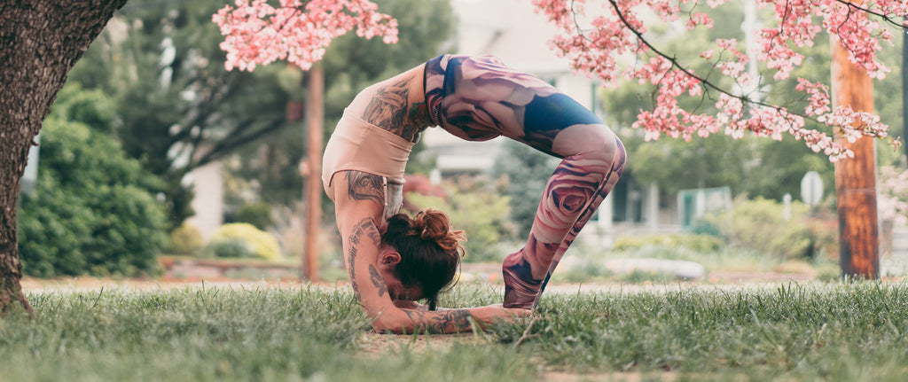 Girl doing an advanced wheel yoga pose while wearing WERKSHOP blush leggings