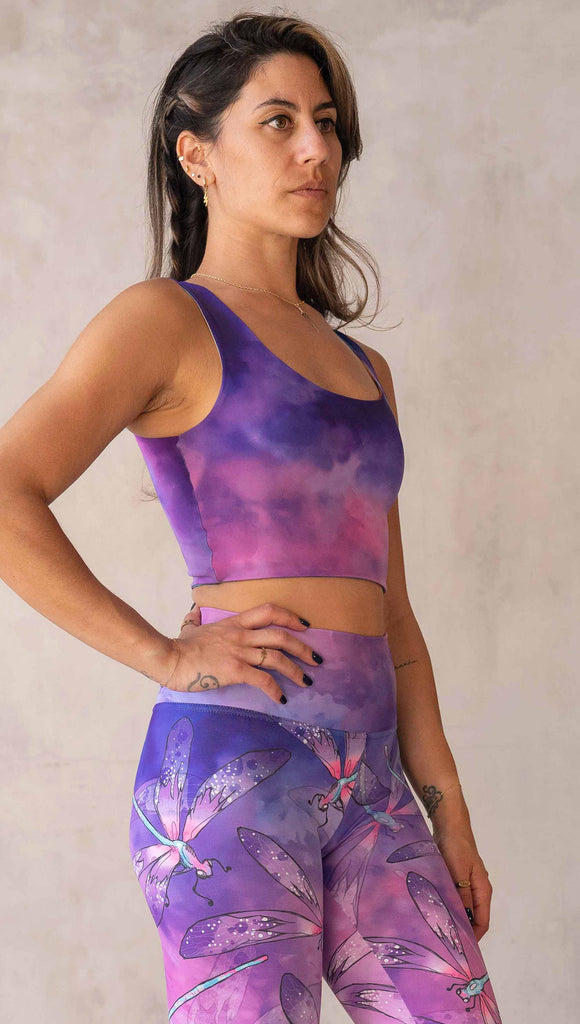 Model wearing WERKSHOP Butterflies and Dragonflies Reversible top. This image shows the "dragonflies" side with a purple and pink watercolor print. It matches our Dragonflies leggings.