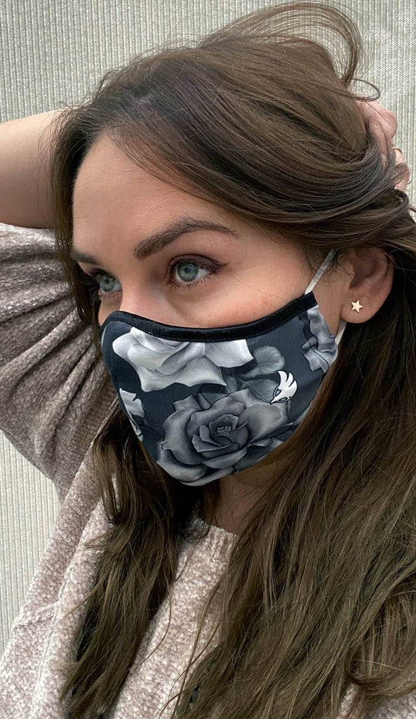 girl wearing face mask with black and white roses artwork