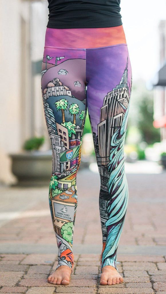 closeup front view of model wearing full length printed leggings with various cities design