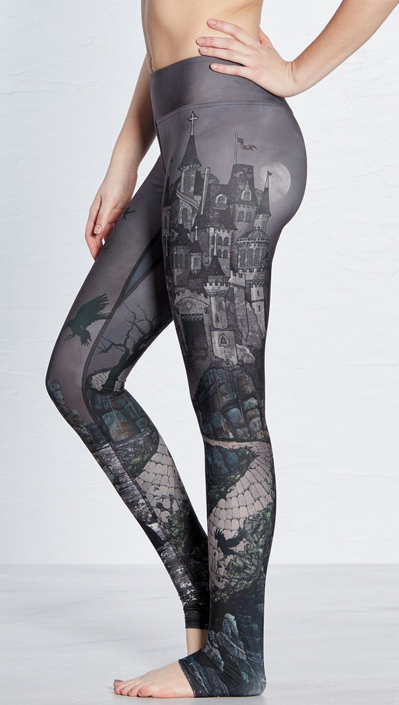 closeup left side view of model wearing castle design printed full length leggings