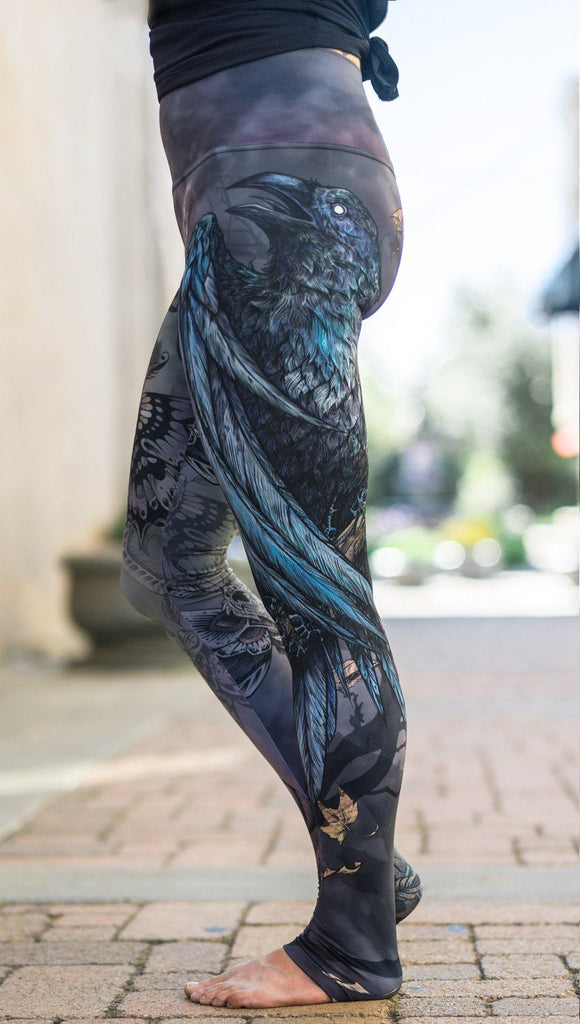 close up left side view of model wearing mashup gothic themed printed full length leggings