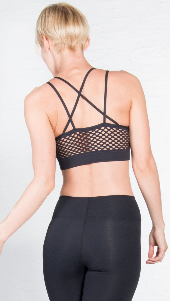 back closeup view of model wearing black sports bra with matching leggings