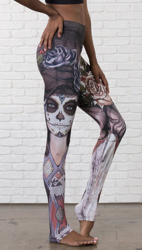 closeup right side view of model wearing mashup Sugar Skull and Dia De Los Muertos themed printed full length leggings