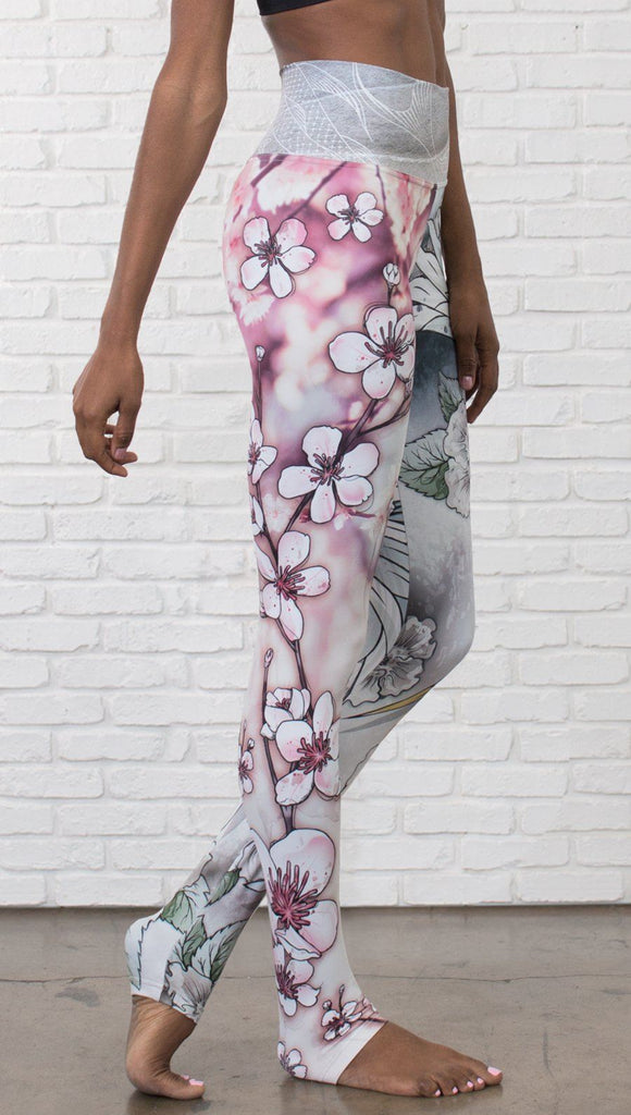 closeup right side view of model wearing Cherry Blossom, Swooping Crane and Koi Fish themed printed full length leggings