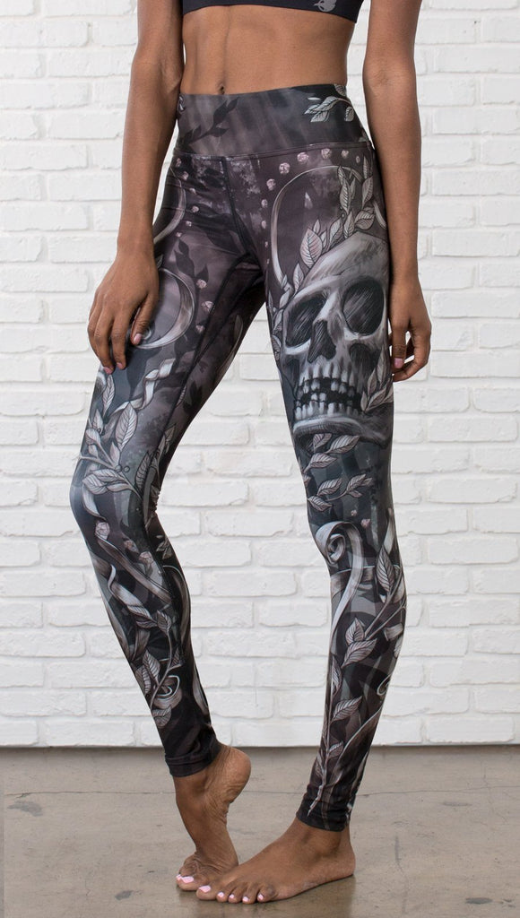 close up front view of model wearing gothic themed printed full length leggings