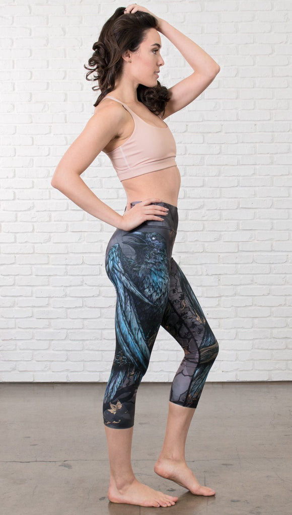 right side view of model wearing gothic themed printed capri leggings