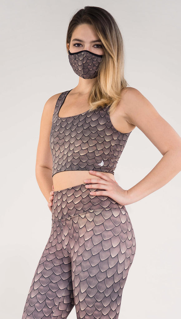 Left side view of model wearing the Dragon/ Leopard top in the Dragon side in the color brown
