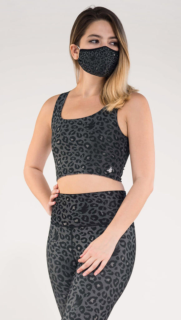 Left side view of model wearing the Dragon/ Leopard top in the Charcoal Leopard side in the colors gray and black