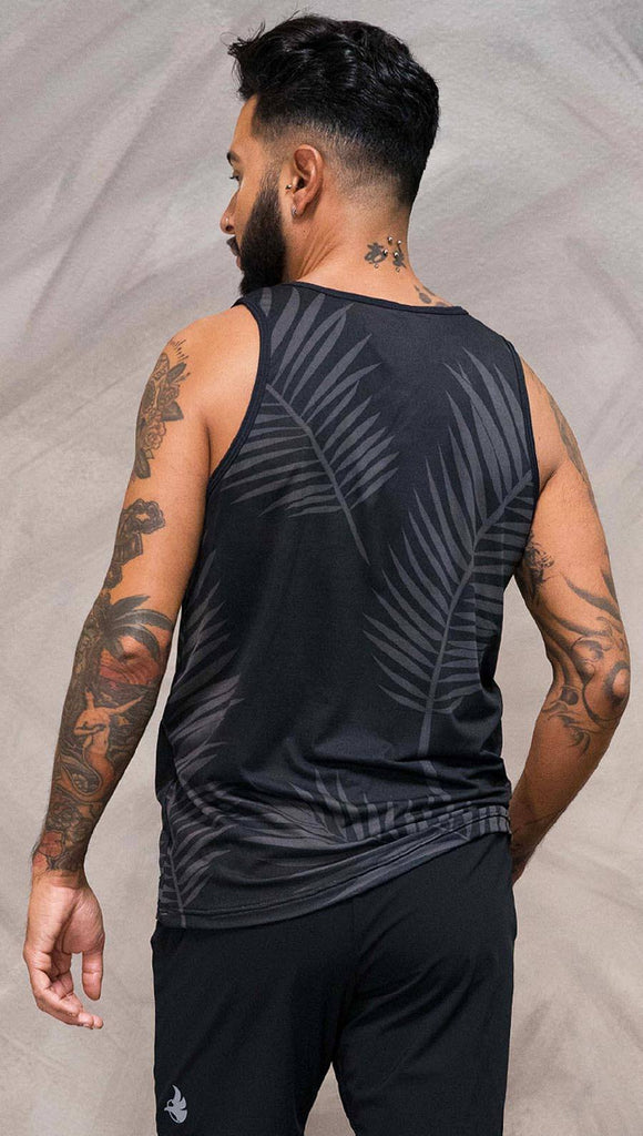 Close up back view of model wearing black tank top with white palm art