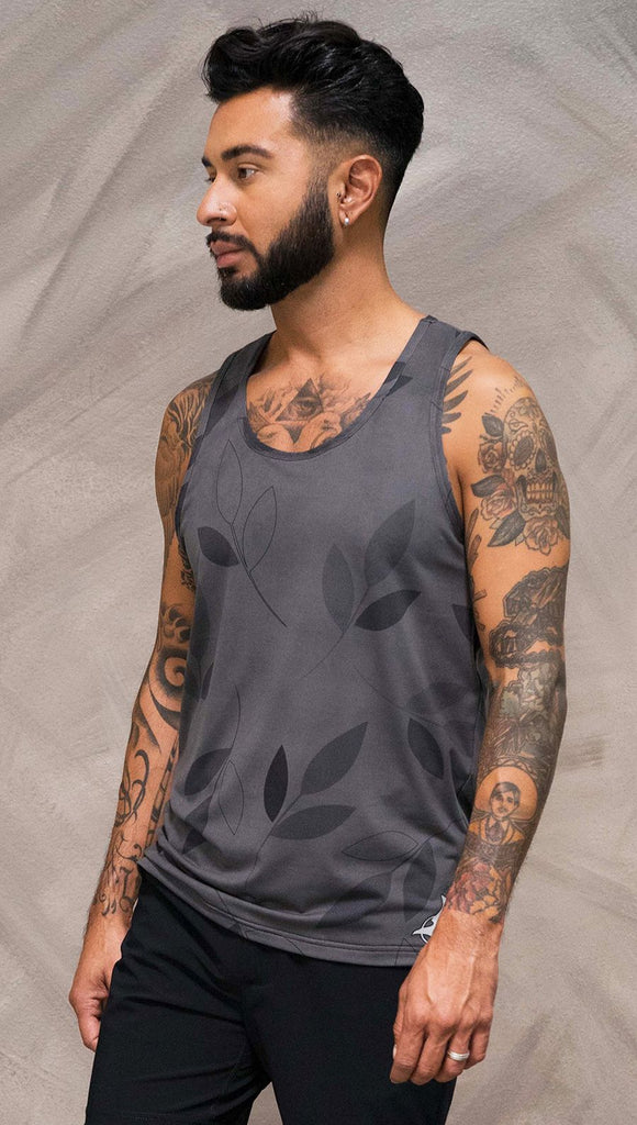 Close up left side view of model wearing gray tank top with vilva leaf inspired art