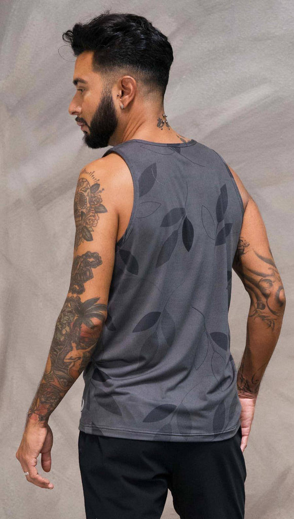 Close up back view of model wearing gray tank top with vilva leaf inspired art