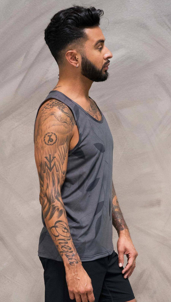 Close up right side view of model wearing gray tank top with vilva leaf inspired art
