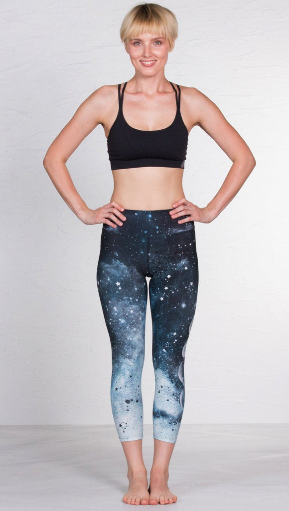 front view of model wearing moon cycle design printed capri leggings