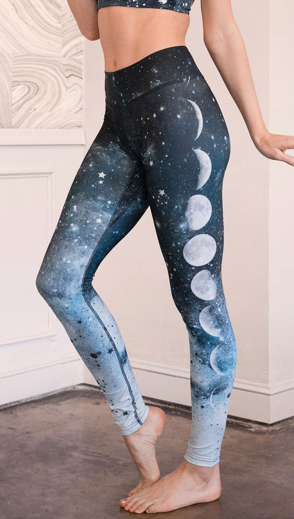 closeup left side view of model wearing moon cycle themed full length leggings