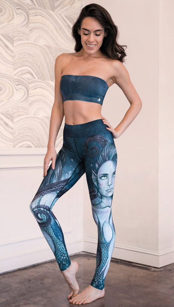left side view of model wearing full length leggings with mermaid and tentacles printed design