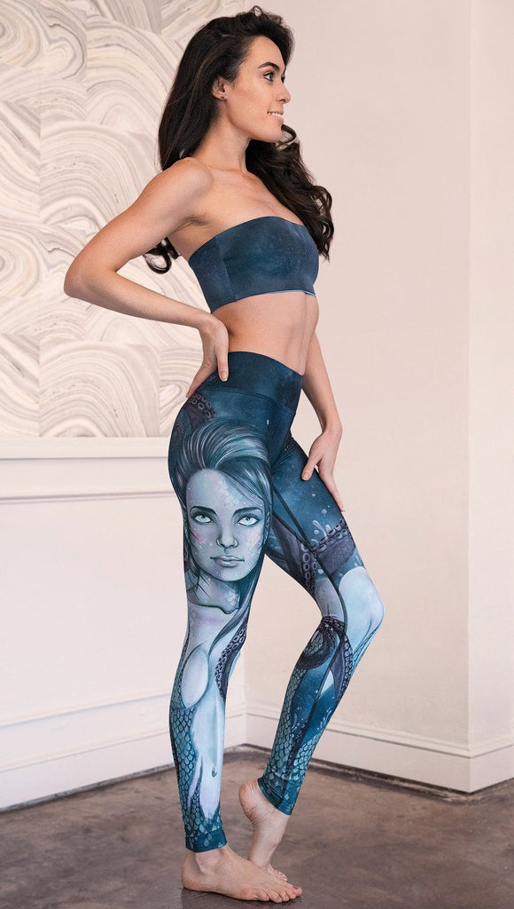 right side view of model wearing full length leggings with mermaid and tentacles printed design