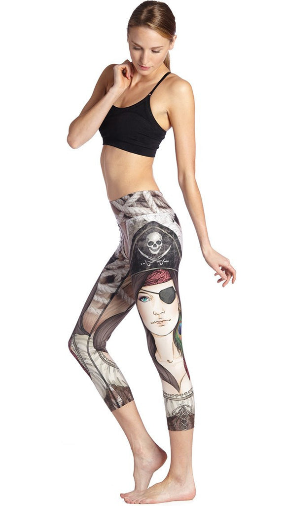 left side view of model wearing pirate girl themed printed capri leggings