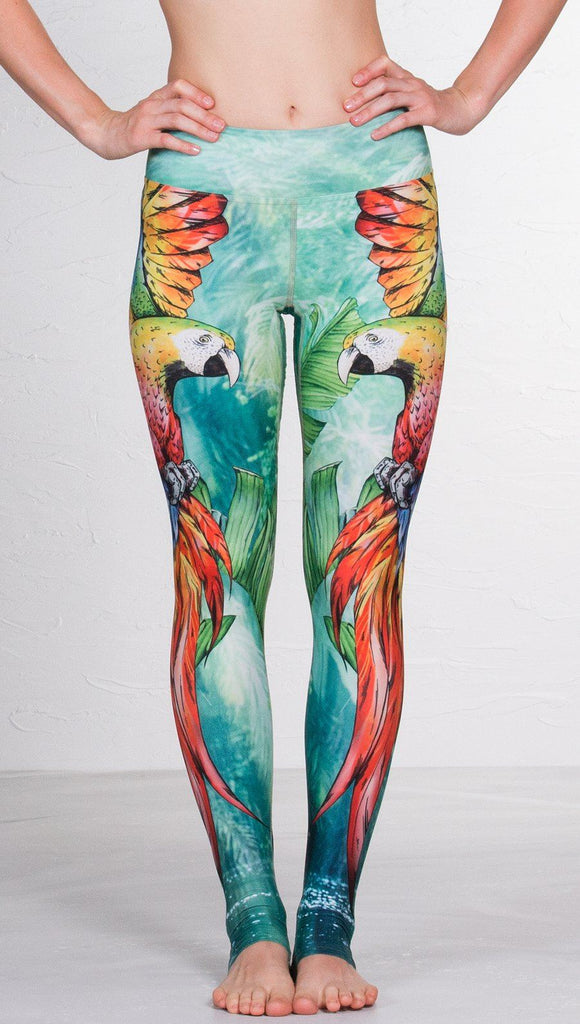 closeup front view of model wearing macaw themed full length leggings