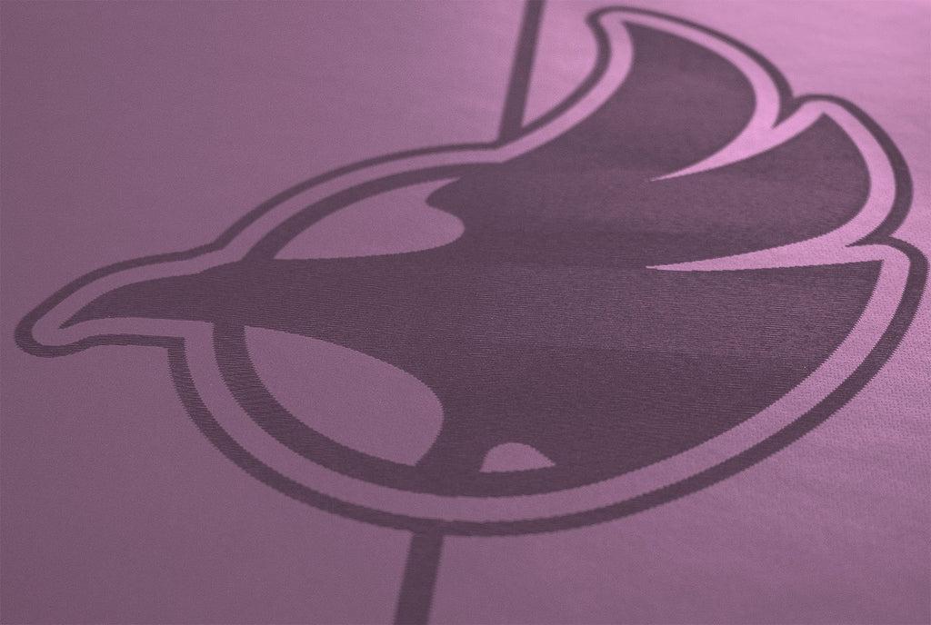 Closeup view of werkshop logo on purple yoga mat 