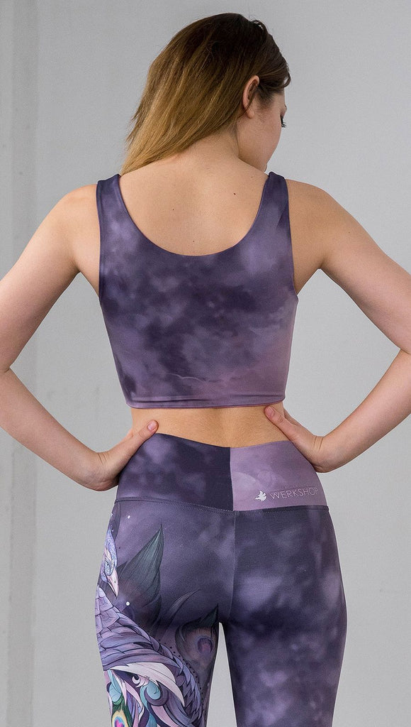 back view of model wearing watercolor inspired reversible tank top with purple on one side and mauve/pink on the other side
