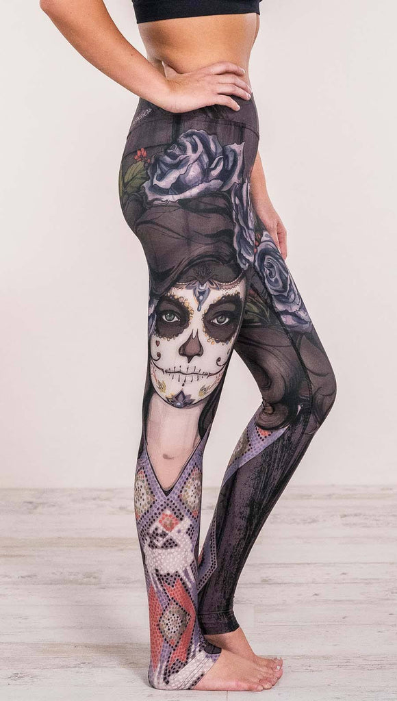 Close up right side view of model wearing sugar skull themed printed full length leggings