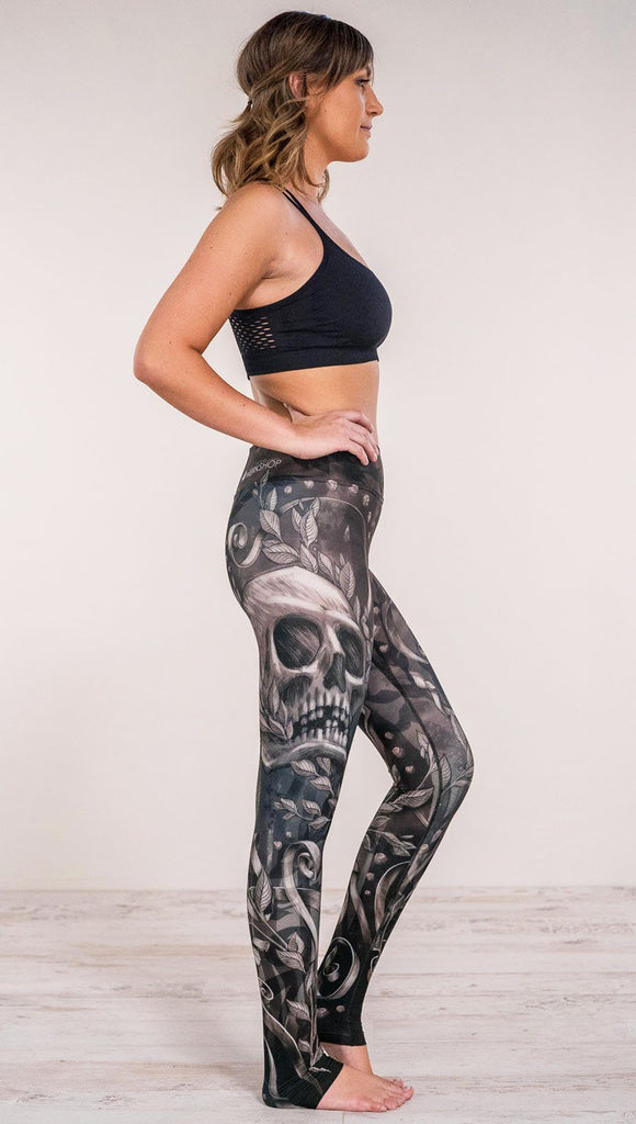 Right side view of model wearing gothic themed printed full length leggings