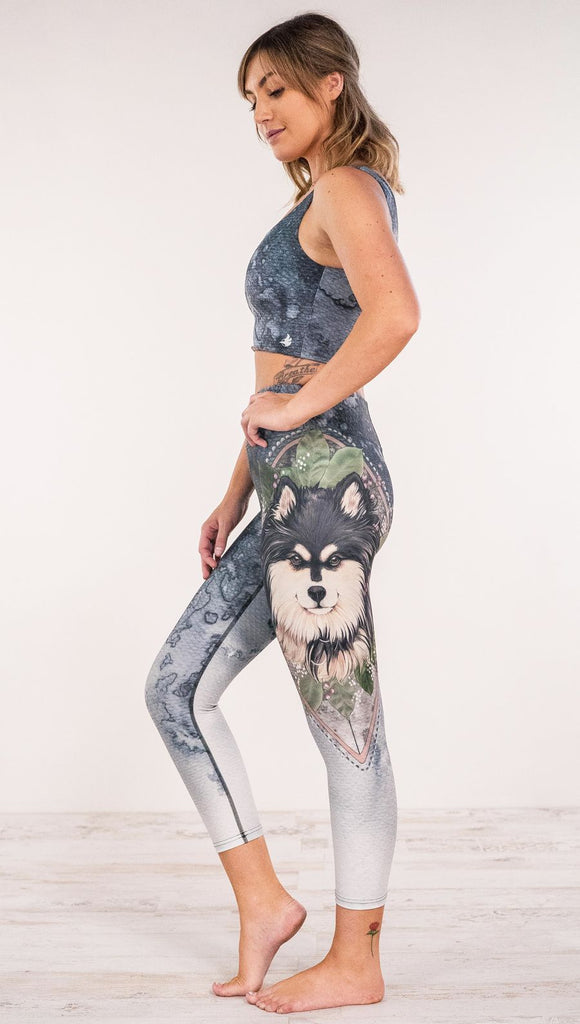 Side view of model wearing Finnish Lapphund artwork themed leggings