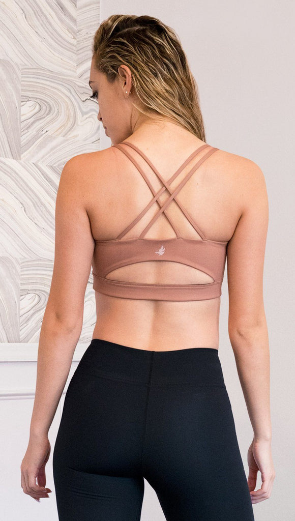 back view of model wearing brown cinnamon colored sports bra