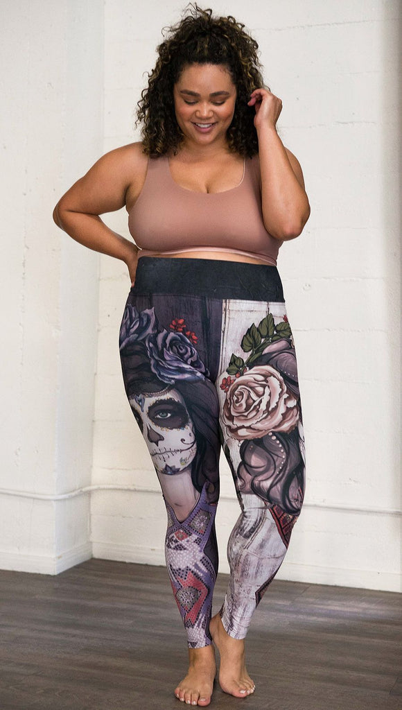 front view of model wearing mashup Sugar Skull and Dia De Los Muertos themed printed full length leggings