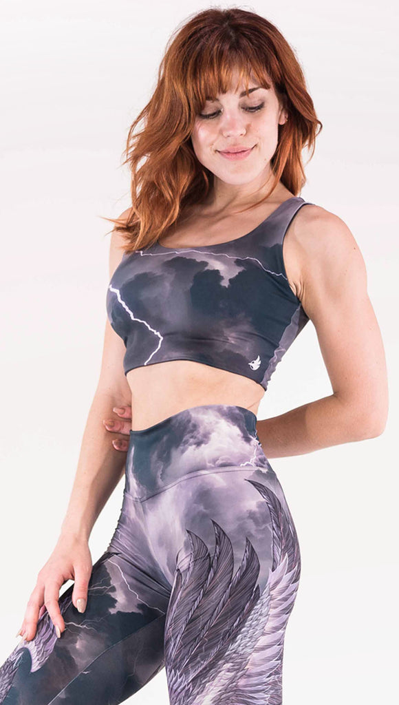 Front view of model wearing the reversible Thunderbird Top in a dark gray and purple with lighting strikes throughout