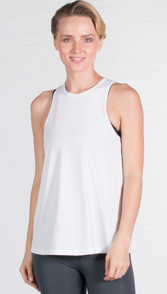 closeup front view of model wearing white tie back sports tank top