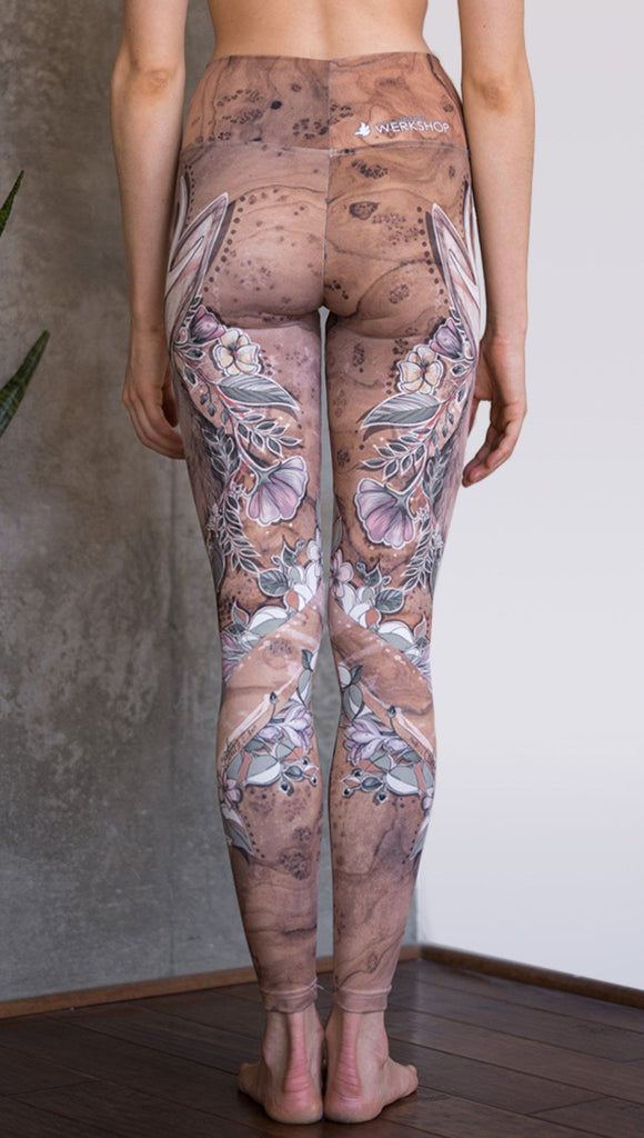 closeup back view of model wearing full length leggings with printed jackalope design