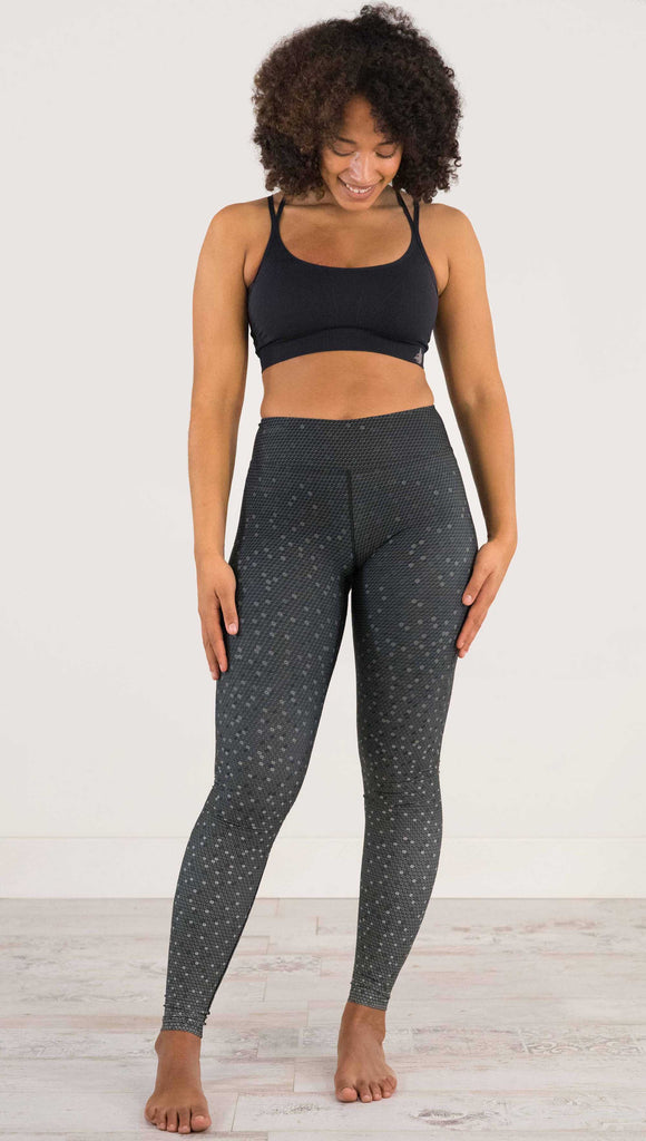 full body front view of model wearing WERKSHOP Black Ombre Full Length Triathlon Leggings. The artwork is dark charcoal on top and fades to a lighter gray on the bottom - with a lot of texture from bead-like artwork.