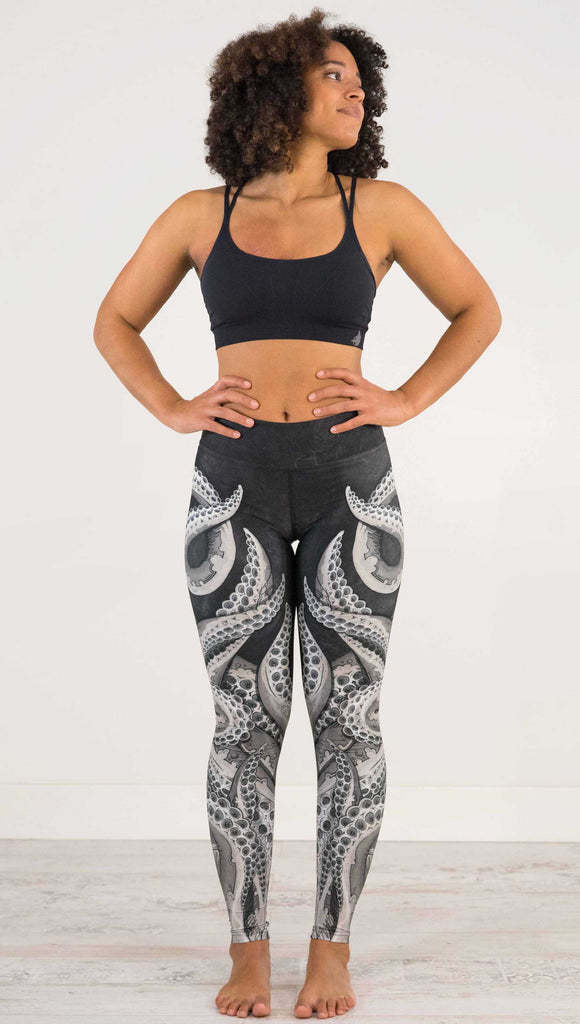 Front full body view of model wearing WEKSHOP Tentacles Full Length Triathlon Leggings. The artwork is monochrome black and white and features large tentacles wrapping around the legs from the bottom reaching upward.