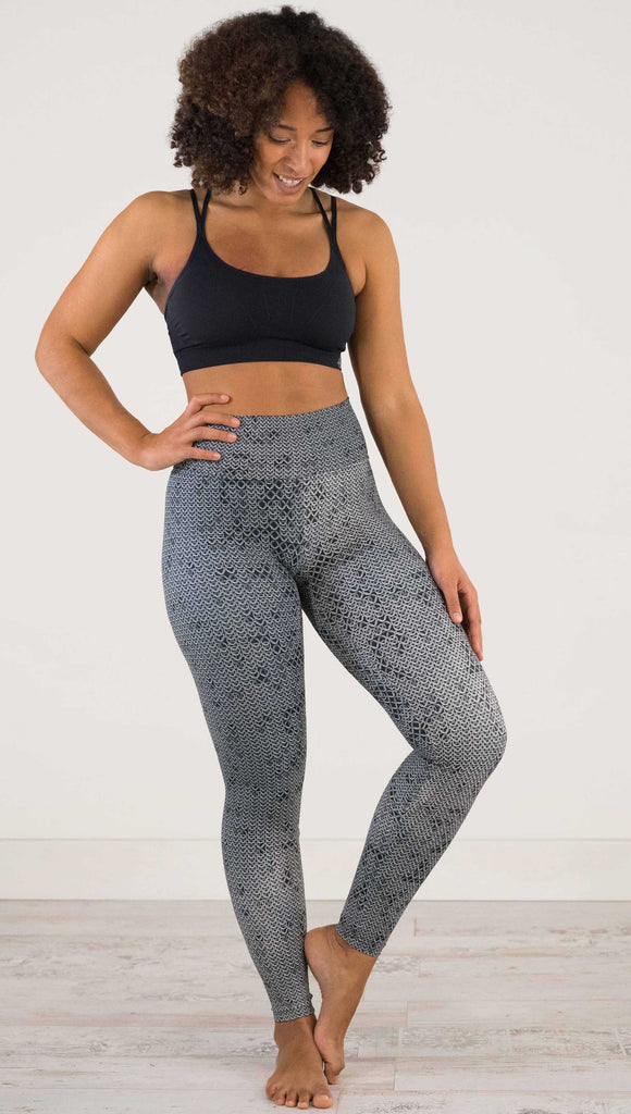 Full body front view of model wearing WERKSHOP Chainmaille Athleisure Leggings. The leggings are printed with a photo-real image of actual chainmaille. Perfect for a Renaissance Festival.