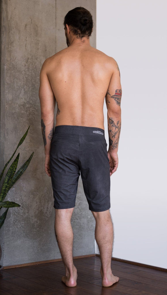 back view of model wearing charcoal black printed mens performance shorts