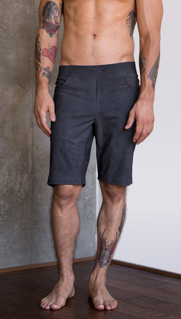 closeup front view of model wearing charcoal black printed mens performance shorts