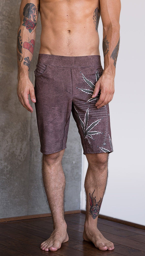closeup front view of model wearing cannabis inspired printed mens performance shorts