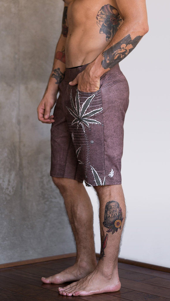 closeup left side view of model wearing cannabis inspired printed mens performance shorts