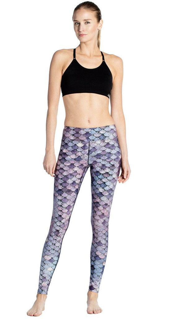 front view of model wearing purple mermaid scale themed printed full length leggings