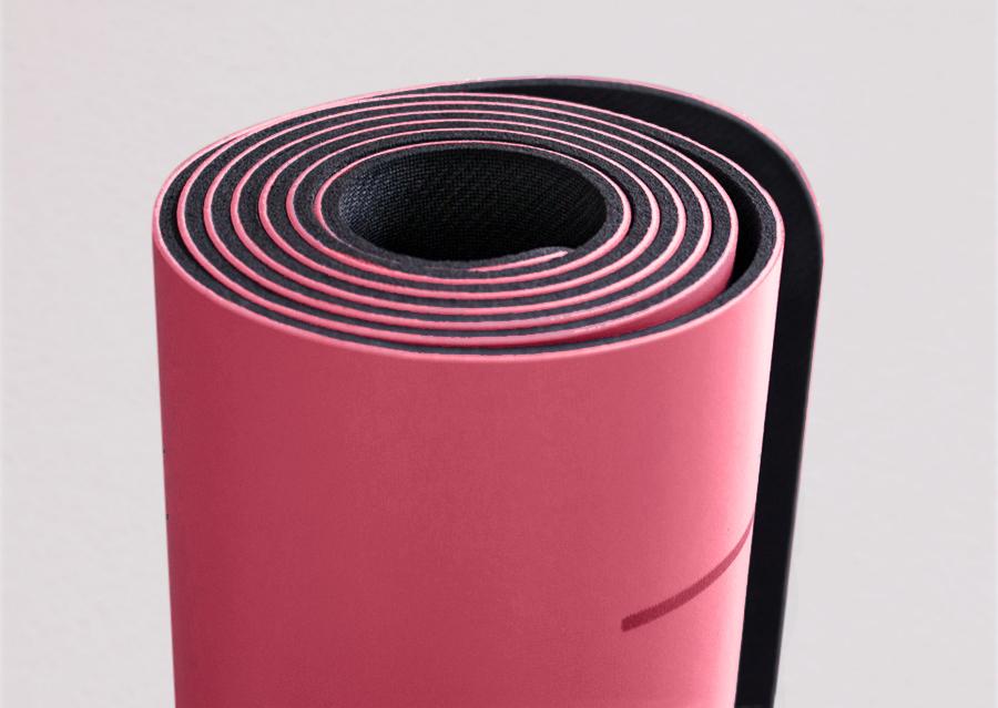 Closeup view of edge of rolled pink yoga mat