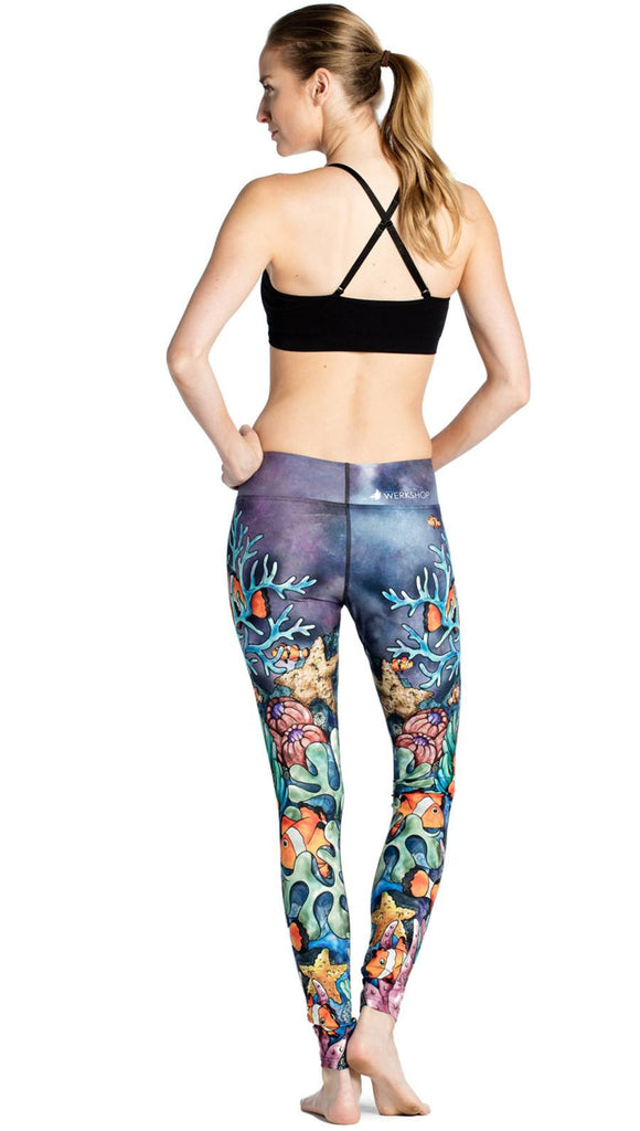 back view of model wearing coral reef themed printed full length leggings