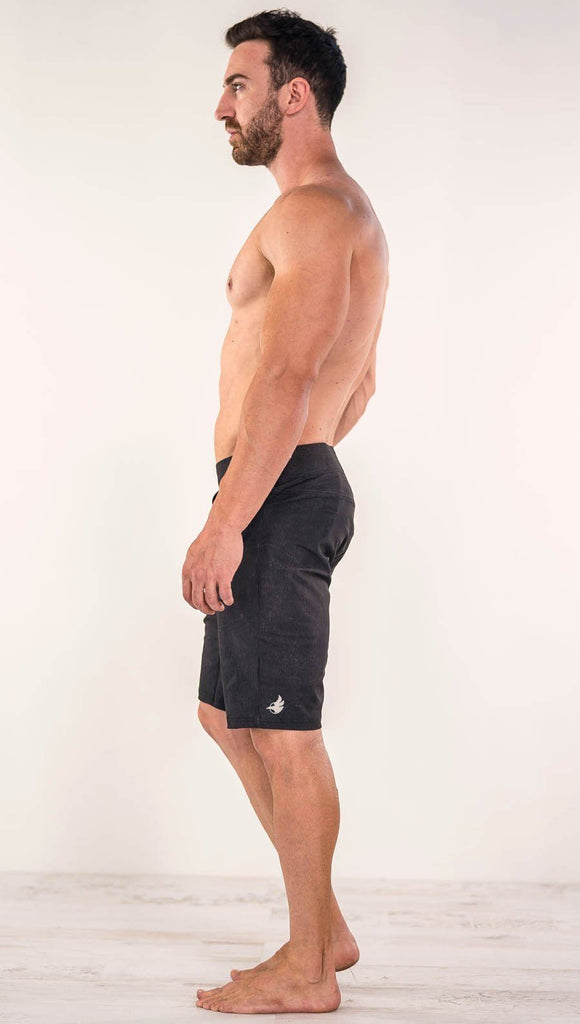 Side view of man wearing WERKSHOP Black Performance Shorts