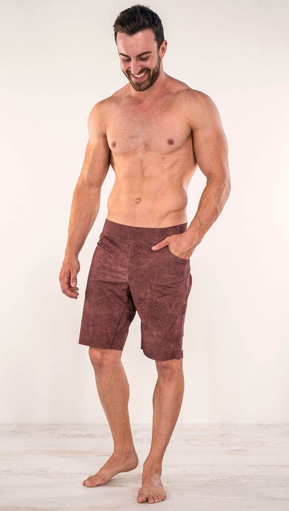Front view of model wearing brick red printed men's performance shorts
