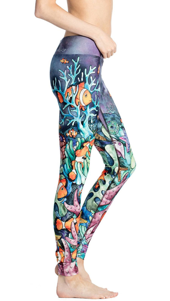 close up side view of model wearing coral reef themed printed full length leggings